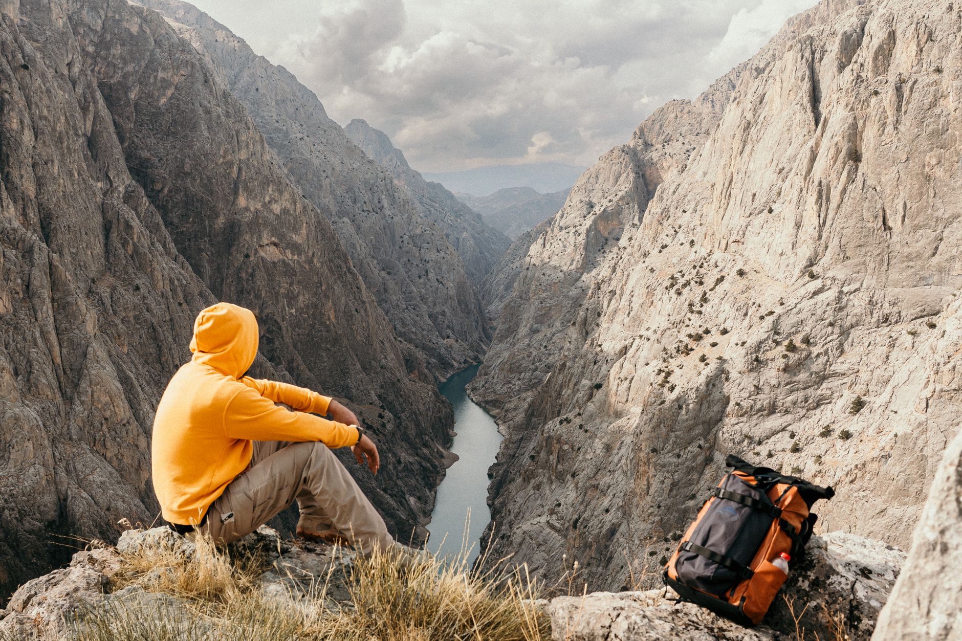 Travel writer reviewing notes on a mountain ridge